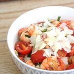 Bowl of shrimp and zucchini noodles topped with parmesan