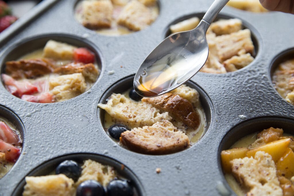 Drizzling mini french toast cups with maple syrup 