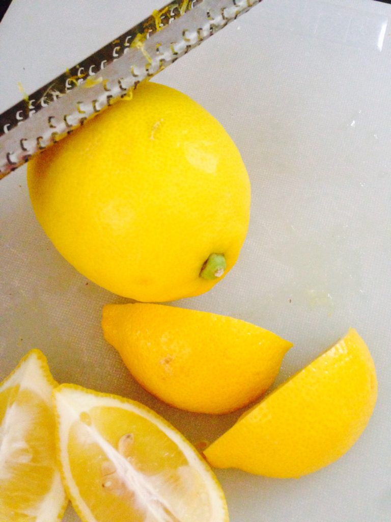 Lemons and lemon wedges being zested