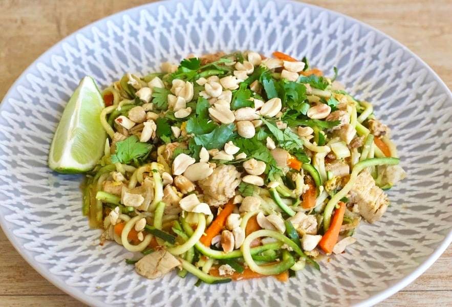 Plate of Zucchini Noodles with chicken, peanuts, carrots and pad Thai sauce