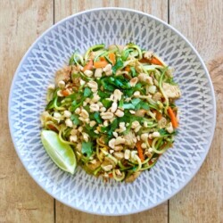 Plate of Zucchini Noodles with chicken, peanuts, carrots and pad Thai sauce