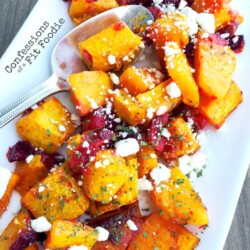 Warm Honey Roasted Butternut Squash Salad, with fresh cranberries and goat cheese. Recipe from Confessions of a Fit Foodie