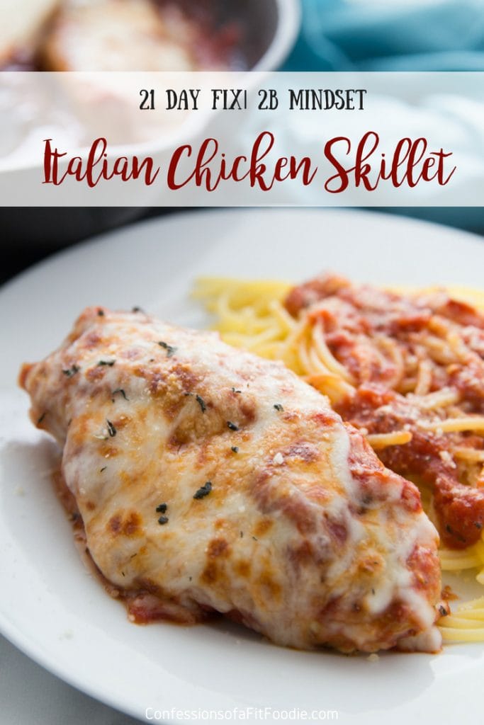 Chicken breast topped with tomato sauce, Italian spices, and melted mozzarella cheese with a side of spaghetti topped with tomato sauce on a white plate- with the text overlay Italian Chicken Skillet, 21 Day Fix | 2B Mindset