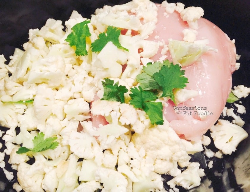 Cauliflower, raw chicken, and cilantro in a crock pot