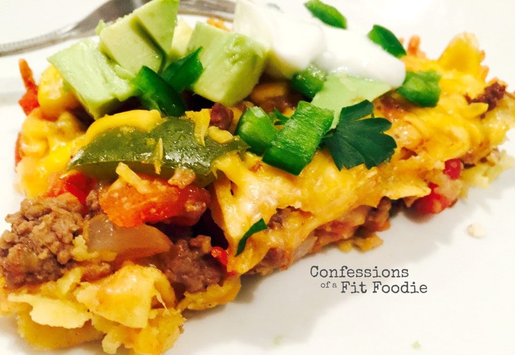 close up photo of a piece of Mexican lasagna on a white plate