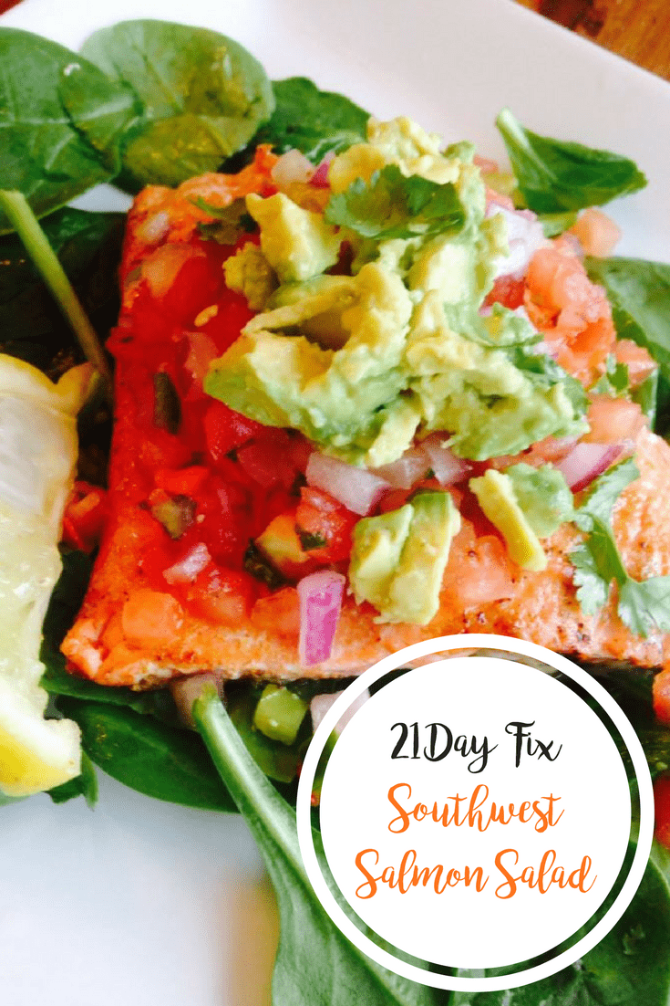 Southwest Salmon over spinach topped with diced ed onion, fresh salsa, cilantro, and avocado with a lemon wedge on the side