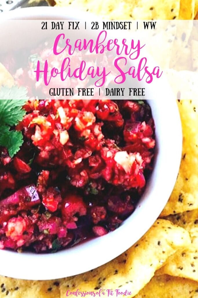 Close up photo of Cranberry Holiday Salsa in a white bowl with tortilla chips and the text overlay- 21 Day Fix | 2B Mindset | WW | Cranberry Holiday Salsa | Gluten Free | Dairy Free | Confessions of a Fit Foodie
