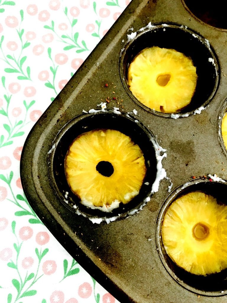 Muffin tins with pineapple rings in the bottom