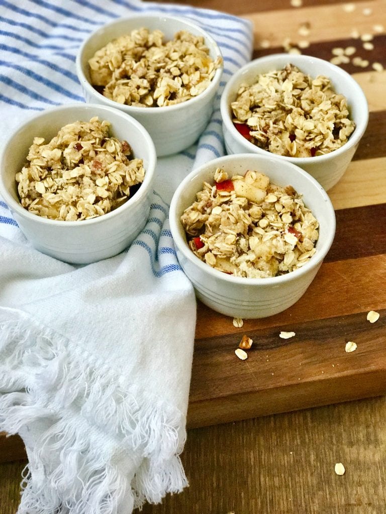 Four ramekins of Instant Pot Apple Crisp ready to cook