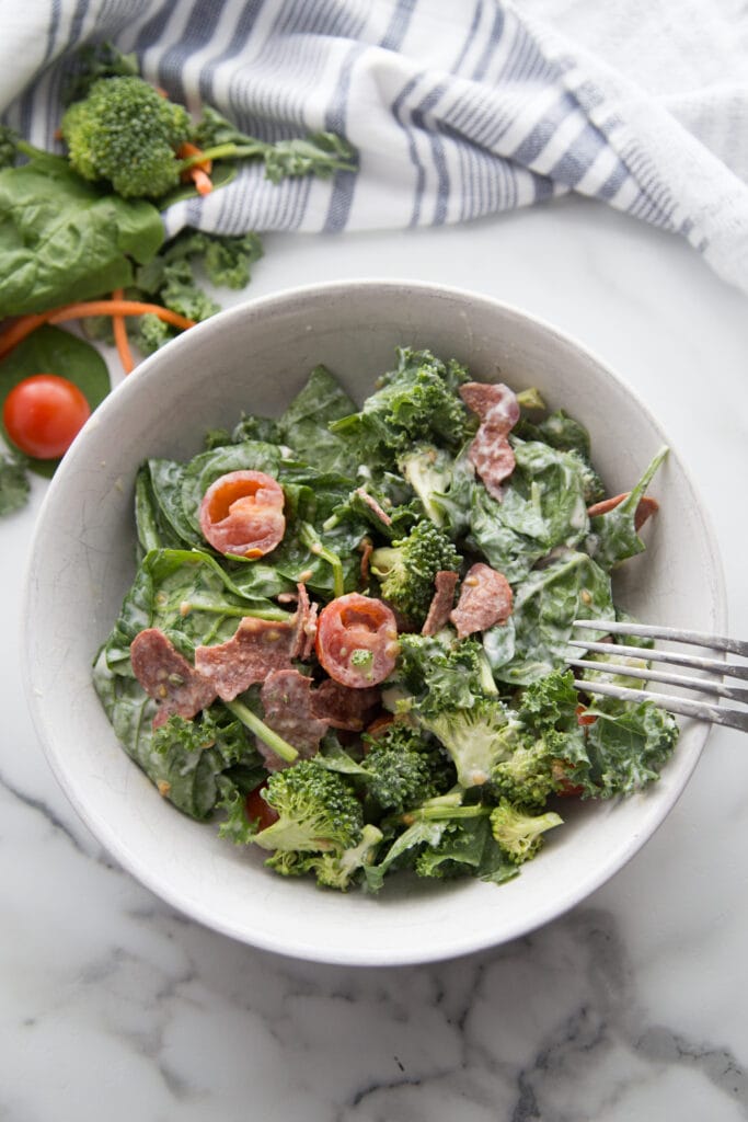 A bowl of BLT salad with tomatoes, bacon, lettuce and broccoli for crunch