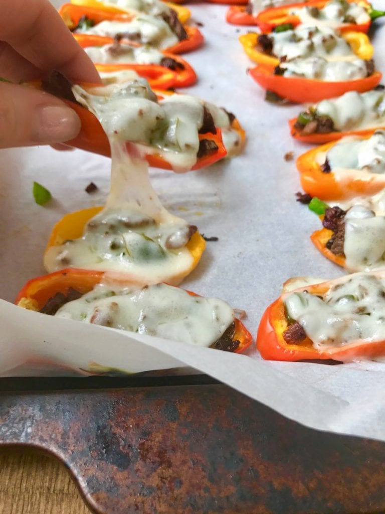 Mini Philly Cheesesteak Stuffed Pepper Nachos made in the Instant Pot, lined on a sheet pan and topped with gooey provolone cheese