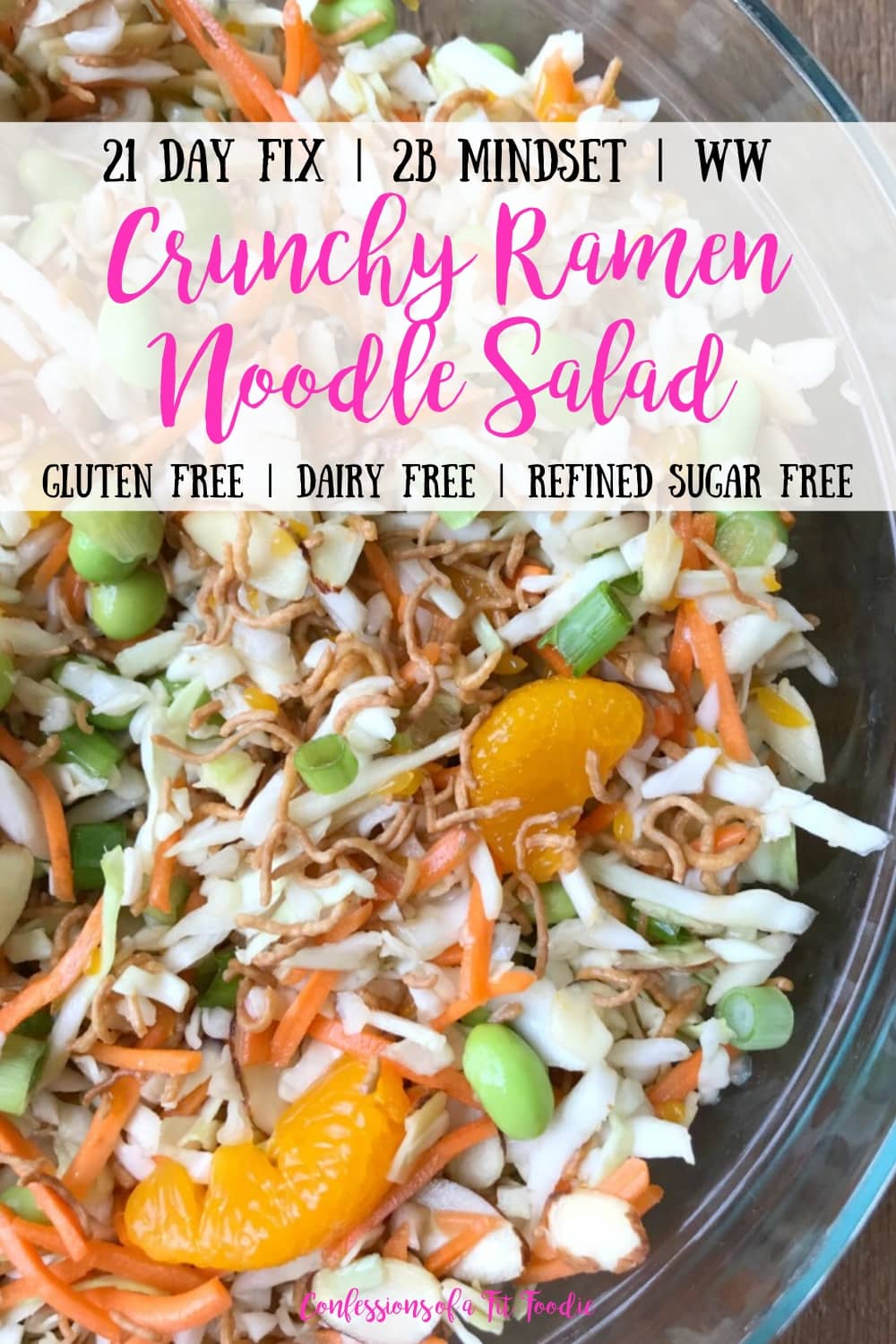Close up of Ramen Noodle Salad Tossed Together in a glass bowl on a wooden surface. With the text overlay- 21 Day Fix | 2B Mindset | WW | Crunchy Ramen Noodle Salad | Gluten Free | Dairy Free | Refined Sugar Free | Confessions of a Fit Foodie