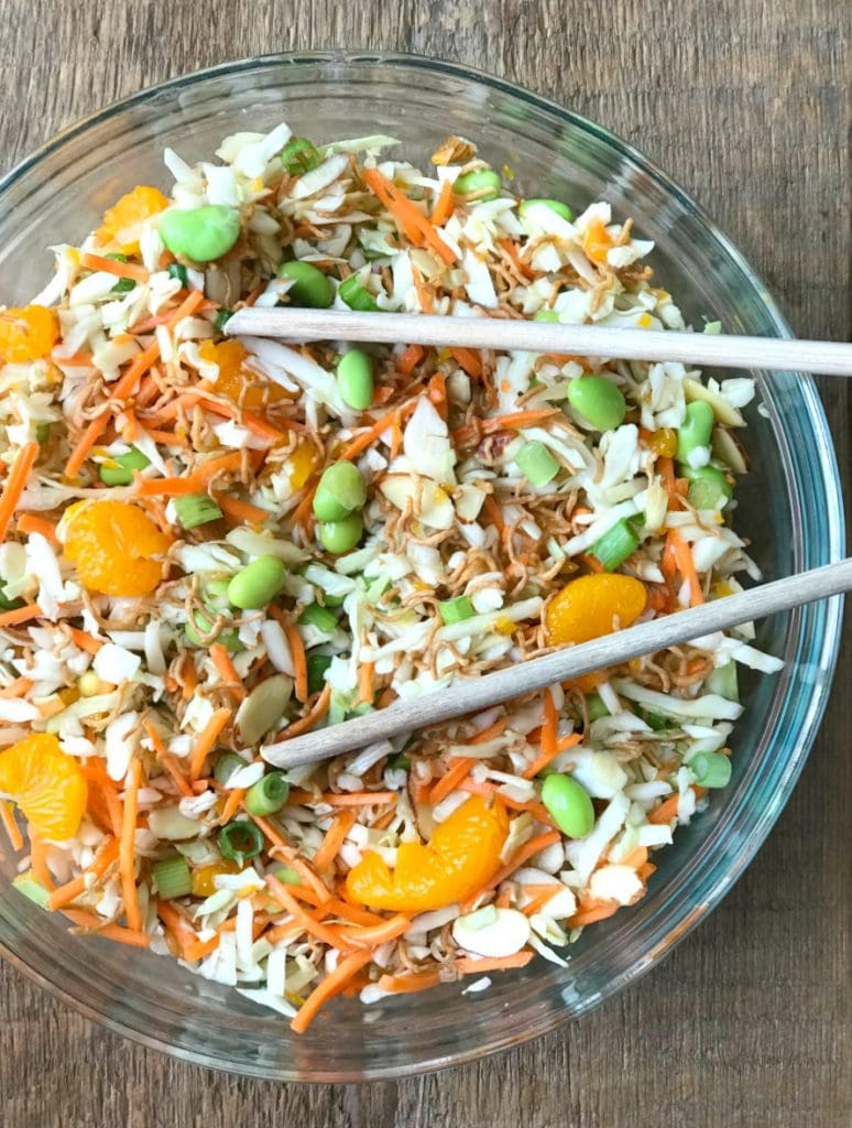 Ramen Noodle Salad in a Glass Bowl with Wooden tongs