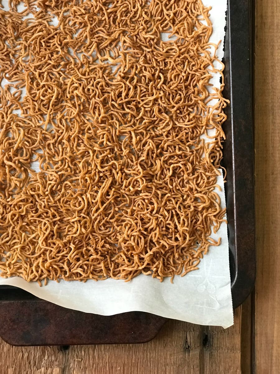 Toasted Ramen Noodles on a parchment paper lined Sheet Pan