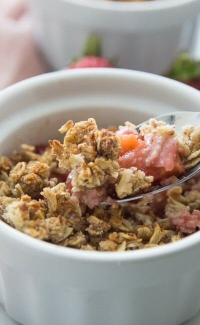 Ramekin with a Spoon full of Healthy Strawberry Rhubarb Crisp