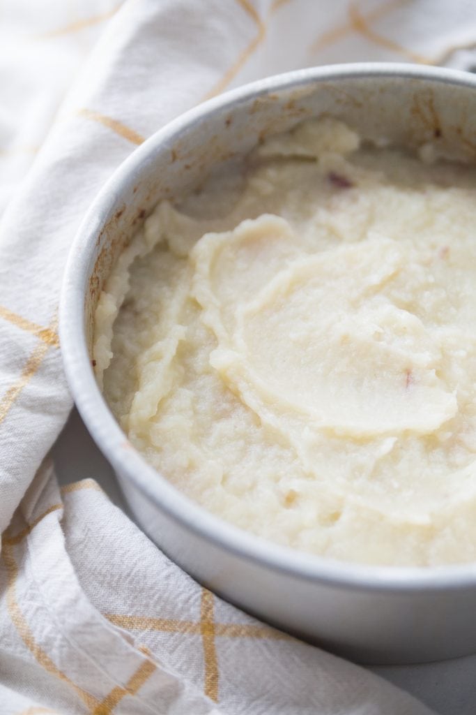 Aluminum plate with healthy shepherd's pie topped with mashed cauliflower and mashed potatoes sitting near an Instant Pot