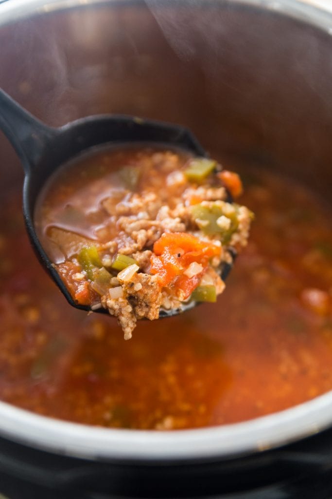 Ladle with a big scoop of Low Carb Stuffed Pepper Soup in the Instant Pot