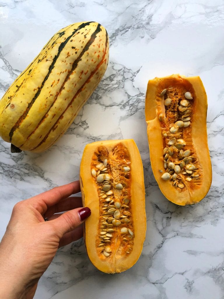 Delicata squash halves on a marble table