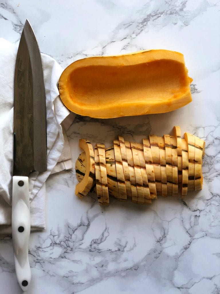 Sliced delicata squash on a marble countertop