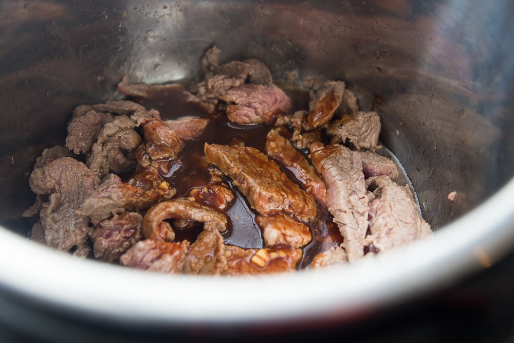 Instant Pot with sliced flank steak 