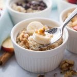 A small ramekin of Instant Pot Steel Cut Oats topped with banana and walnuts.