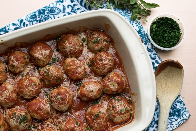 Turkey meatballs, lined in a baking dish covered in sauce