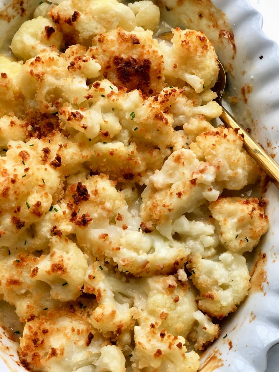 Overhead image: crispy roasted cauliflower in cheese sauce 