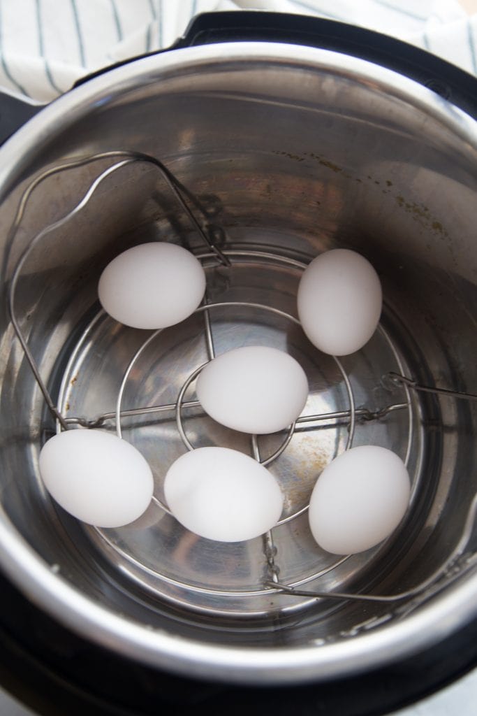 Overhead photo of eggs in and instant pot on a metal trivet.