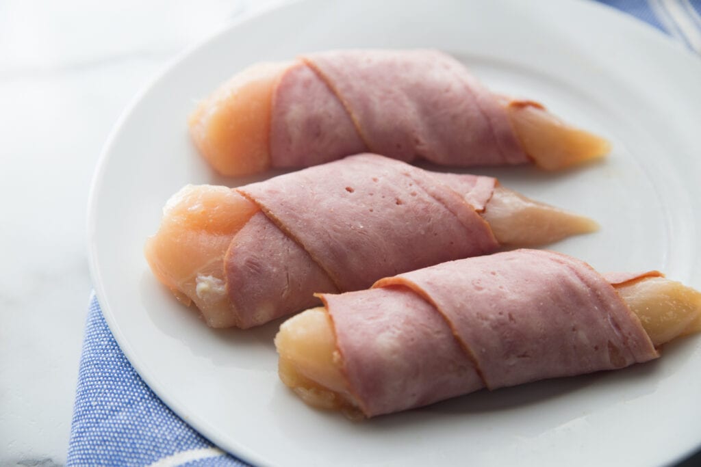 A plate of chicken tenders wrapped in bacon 