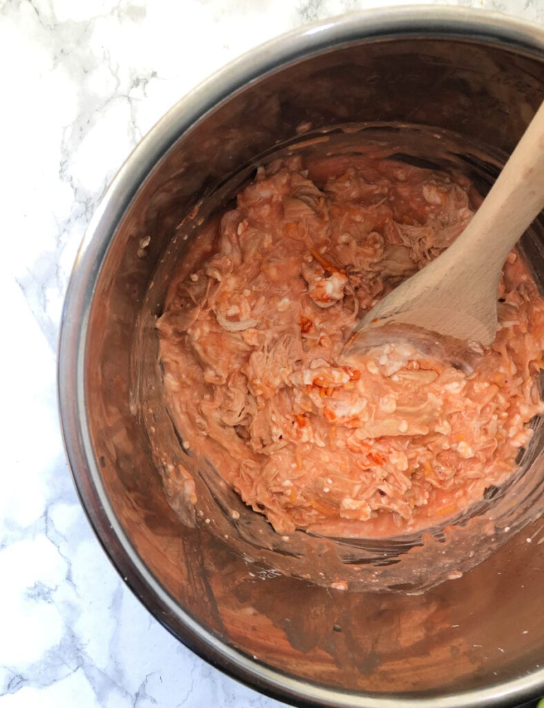 An Instant Pot filled with a Buffalo Chicken Mixture
