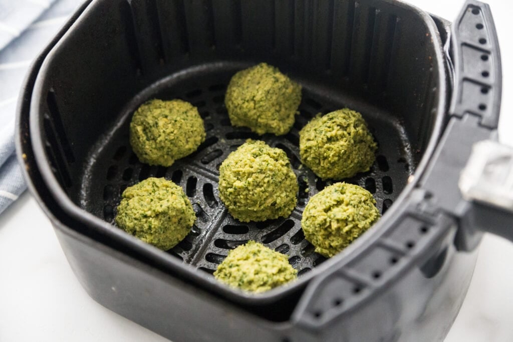Air Fryer Basket full of Easy Falafel Bites ready to be cooked