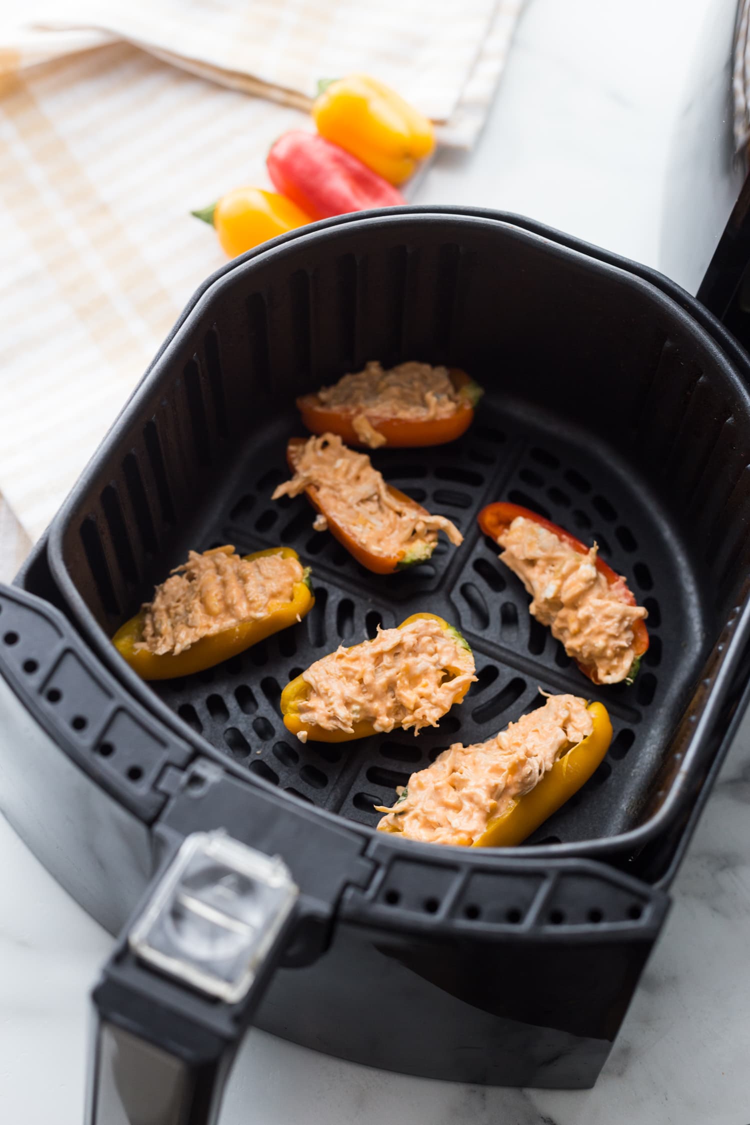 Healthy Buffalo Chicken Stuffed Peppers in the air fryer basket