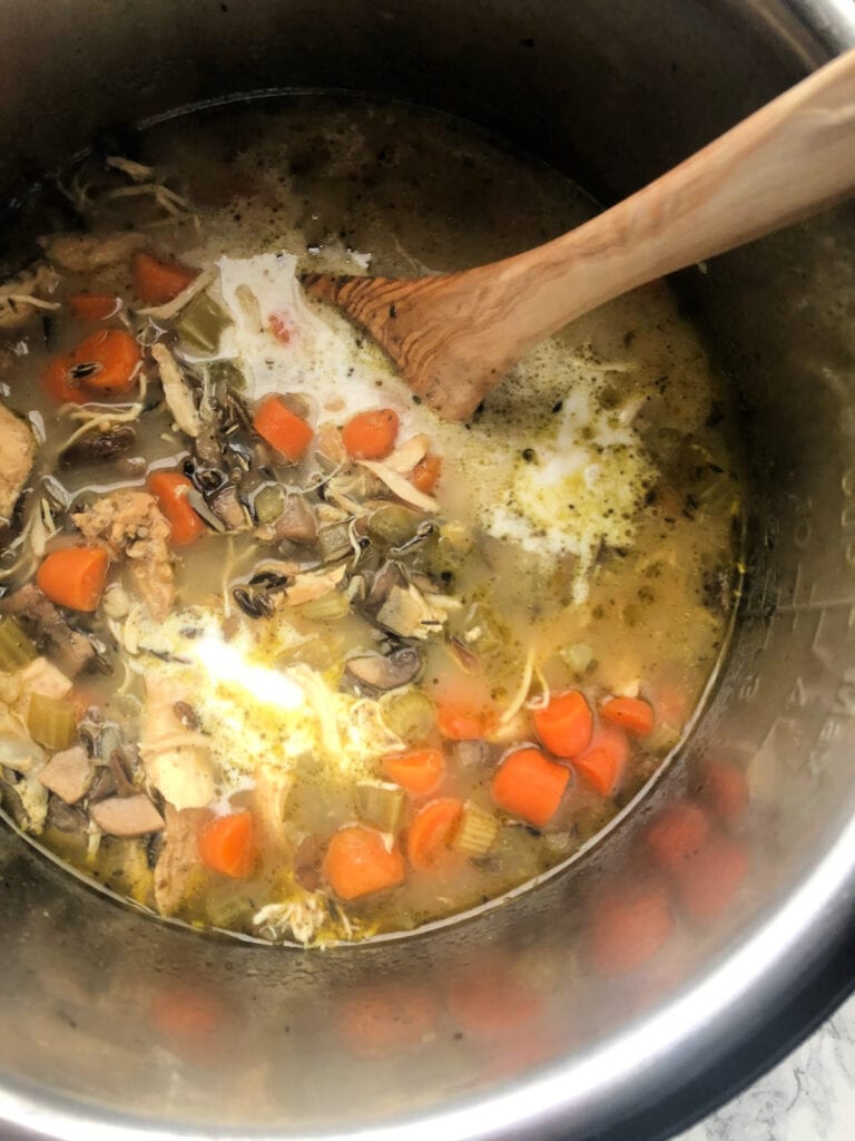 Cooked Instant Pot Chicken and Wild Rice Soup with coconut milk added, ready to be stirred up and served out of the instant pot.