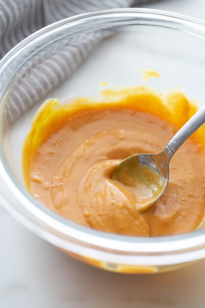 Close up photo of the best burger sauce mixed with a spoon, in a glass bowl.