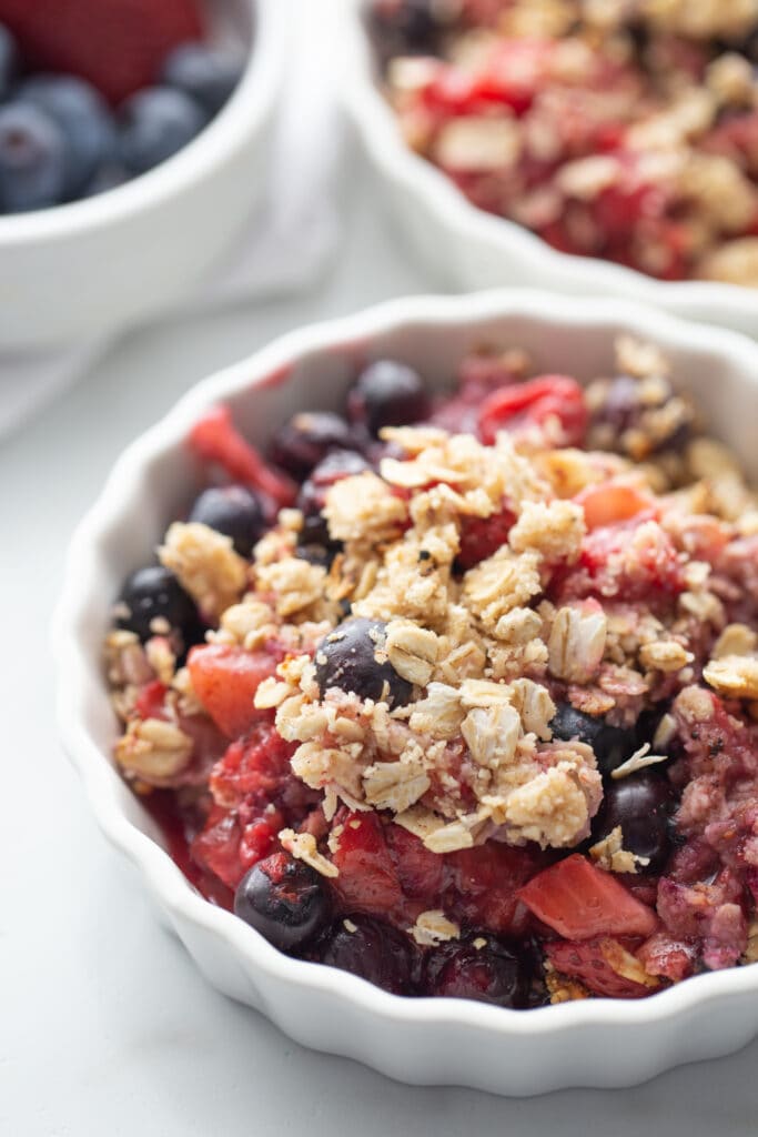 Individual ramekin with berry crisp straight out of the oven.