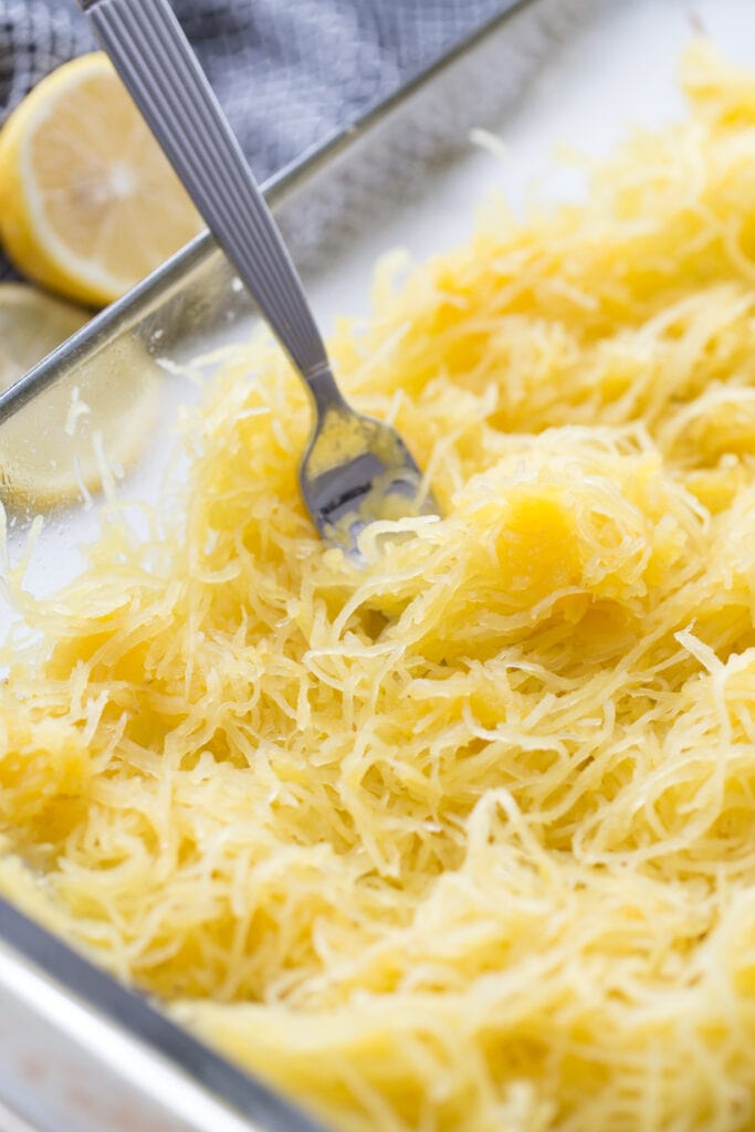 fork in a dish of squash noodles
