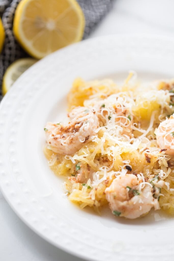 shrimp scampi with spaghetti squash on a white dinner plate