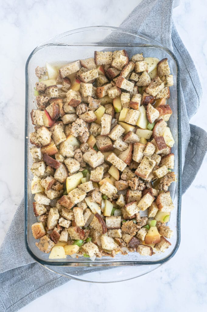 Overhead photo of gluten free stuffing in a glass baking dish, ready for the oven.