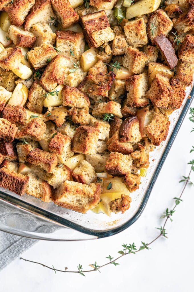 Close up photo of corner of baking dish filled with crispy homemade stuffing