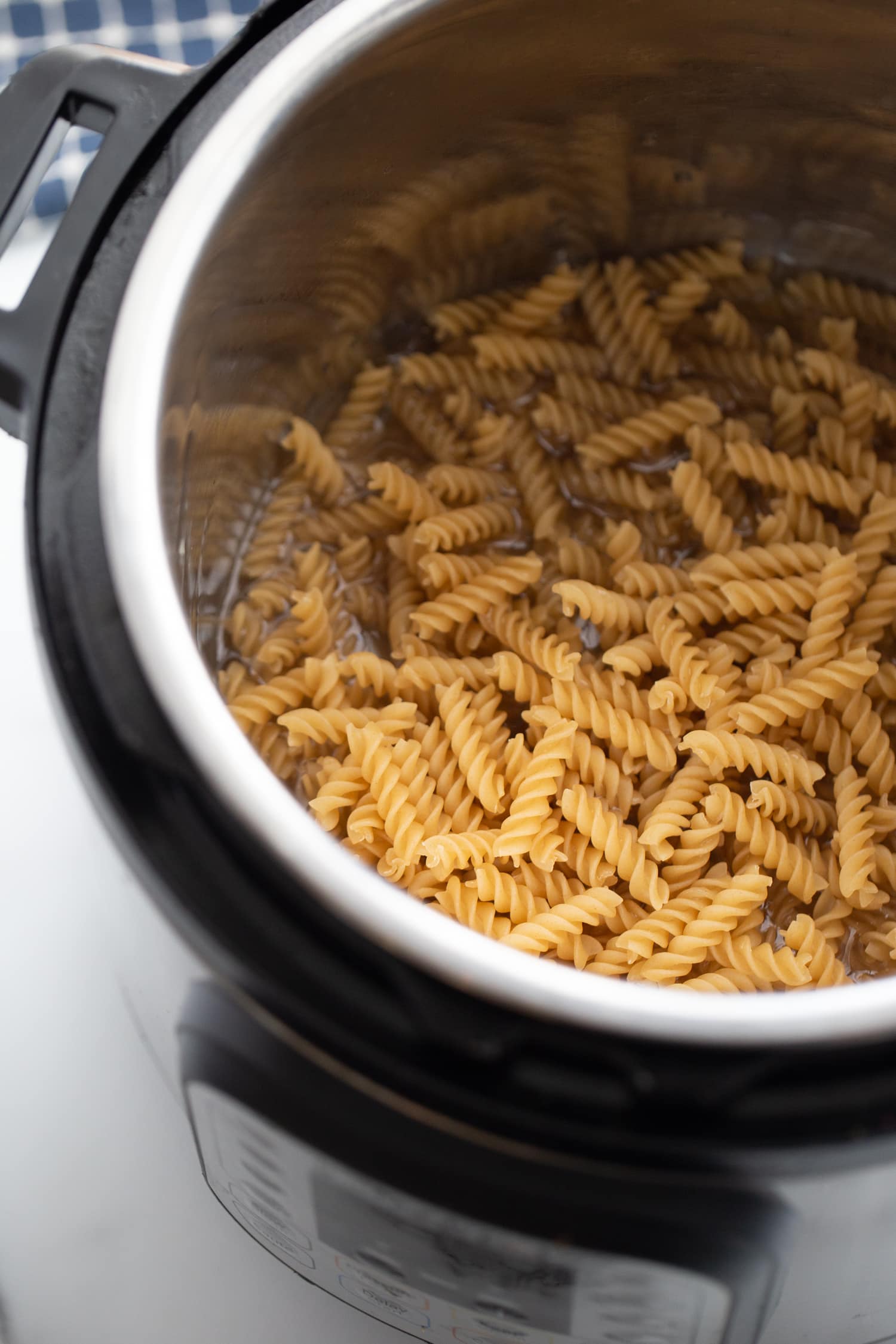 Overhead photo of raw rotini pasta in the instant pot