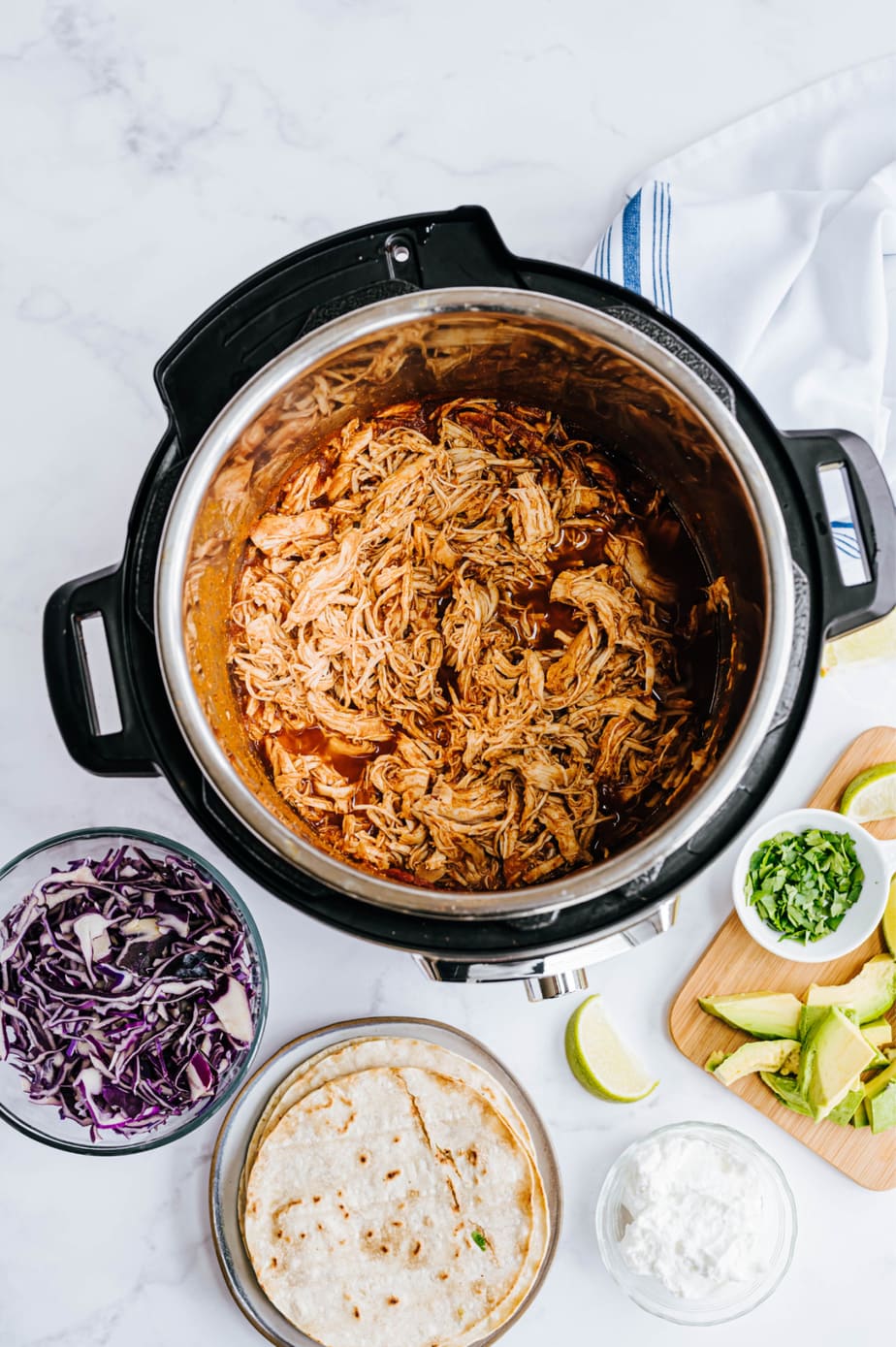 Shredded chicken is in an Instant Pot, ready to be served.