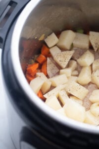 Potatoes and carrots are set in the Instant Pot.