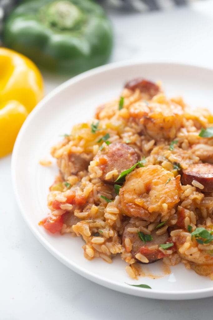 A white plate presents a perfect portion of healthy jambalaya.