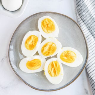A plate is presented with 6 pieces of halved hard boiled eggs.