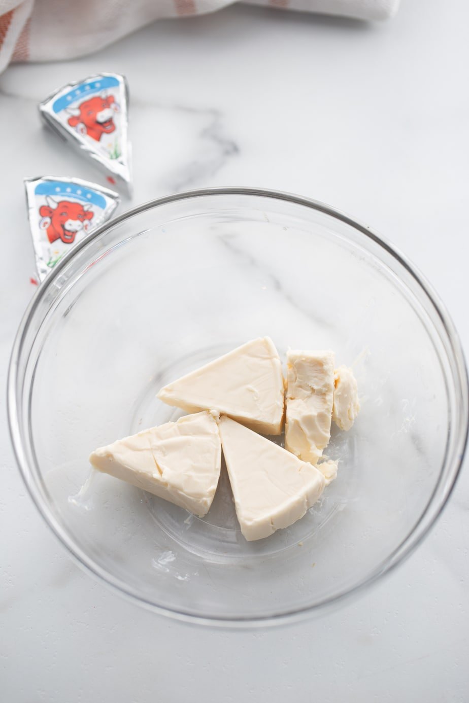 Creamy light cheese triangles in a glass bowl