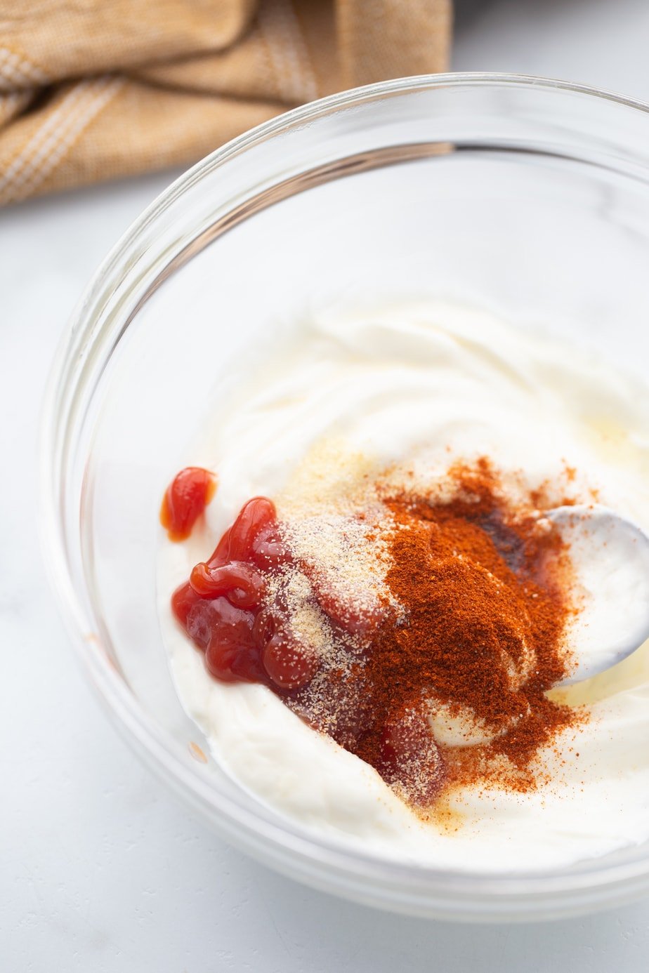 A small glass bowl contains the ingredients for yum yum sauce.