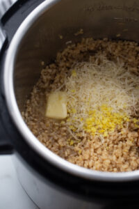 Lemon and parmesan are added to the instant pot.