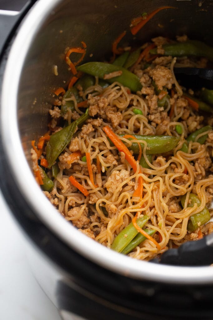 Overhead image: Asian stir fried veggies and ground chicken with ramen noodles in the Instant Pot