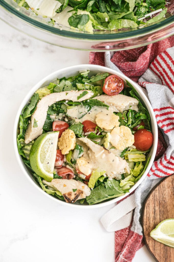 Overhead photo of a bowl of kale Caesar salad with chicken