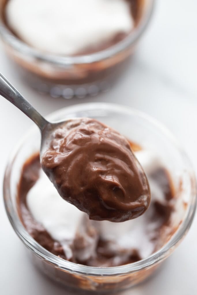 A close up shot of a spoon of homemade vegan chocolate pudding 